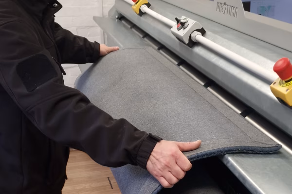 Rug undergoing deep dust removal in Prestige Rug Cleaning’s automated Protima dusting machine London